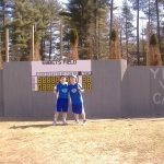 Thomas Hannon and Tom Hannon infront of right field wall